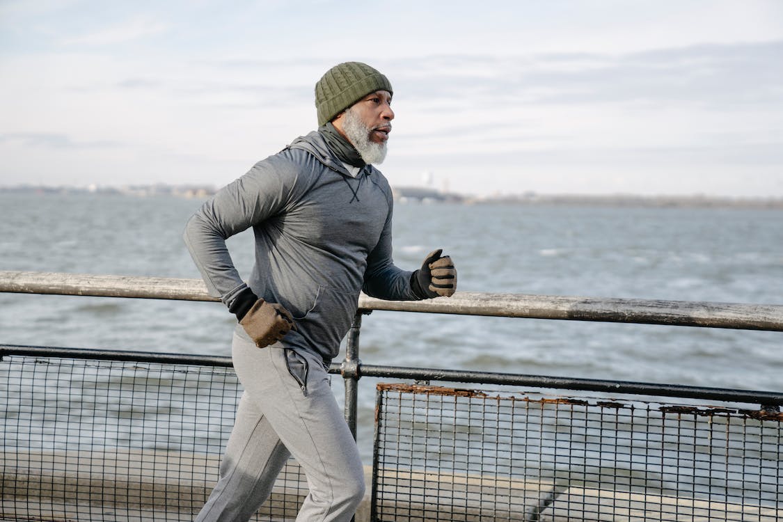 Free Serious black man running on embankment Stock Photo